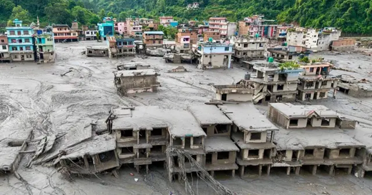 Casas cubiertas de lodo al lado de un río y casas coloridas que no sufrieron los efectos de la avalancha.