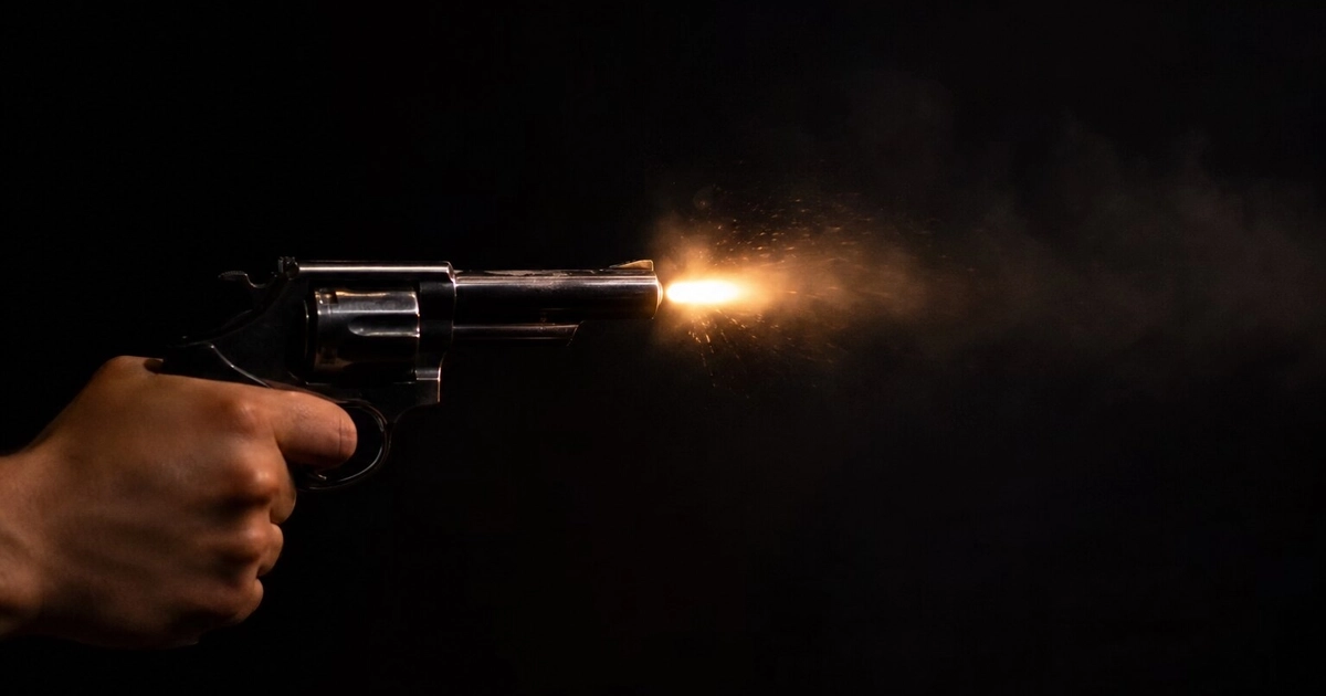 Una mano sostiene un revólver que emite un destello y humo al ser disparado en la oscuridad. (Imagen Ilustrativa Infobae)